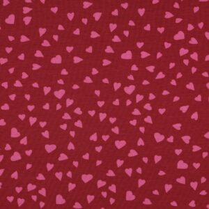 Tissu french terry rouge framboise avec motif de petits cœurs roses répartis sur toute la surface.