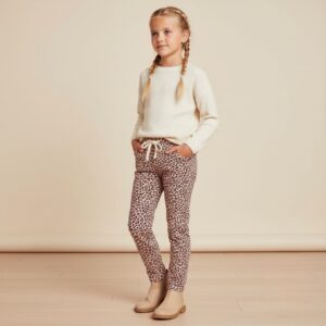 Tissu jersey de coton motif mini léopard noir sur fond rose poudré